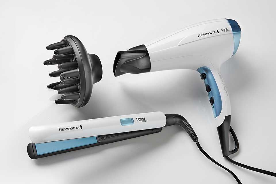 White and teal Shine Therapy hair straighteners and hair dryer with diffuser.