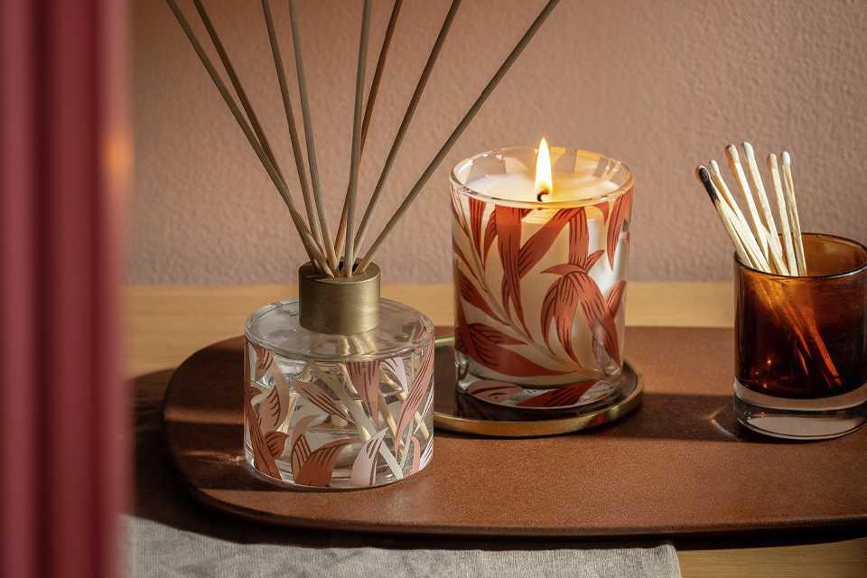 Morris & co candle and defuser on wooden side table.