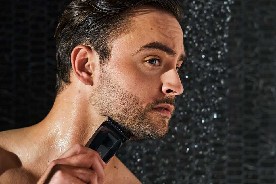 Shot of a man using a Manscaped product to shave his beard.