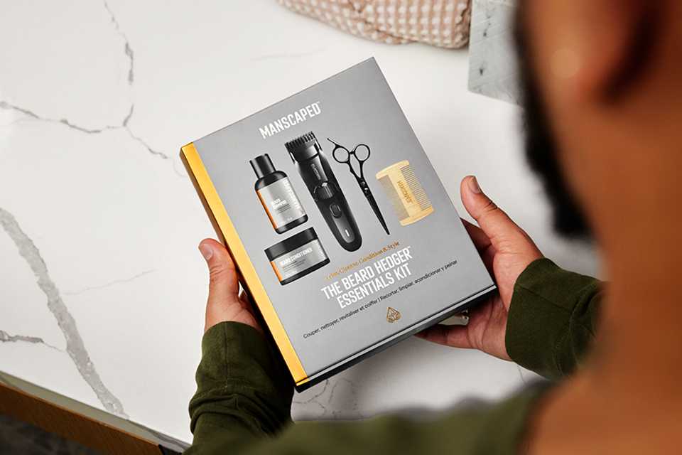 Shot of a person holding the Manscaped Beard Hedger Essentials kit packet.