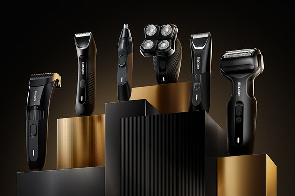 Various black Manscaped mancare products placed on golden podiums against a black background.