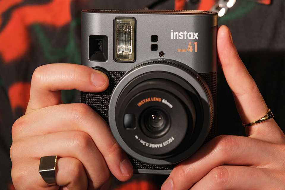 A close up shot of a black instax mini 41™ instant camera.