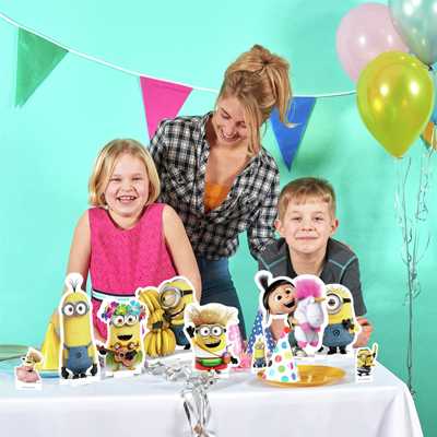 Kids celebrating their birthday with mum in a room decorated with Minions theme party decorations.