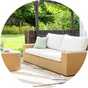 Garden chairs with white cushions in garden.