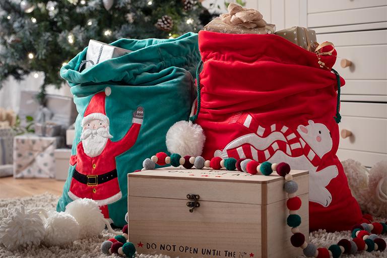 Christmas Eve box and presents next to tree.