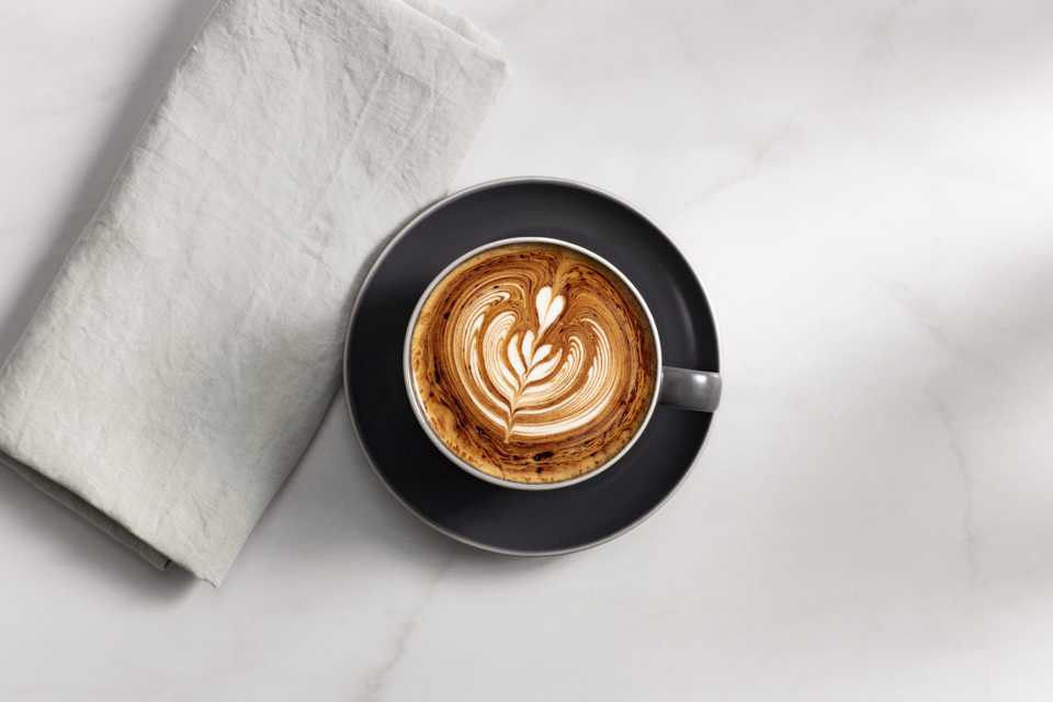 A coffee cup placed on a white table.
