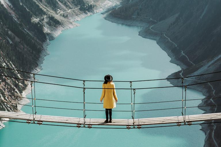 Woman standing on a bridge.