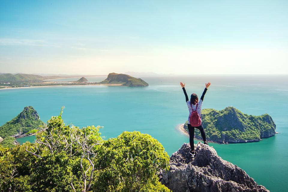 Woman standing on a cliff.