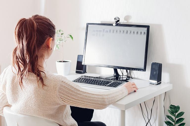 Woman working on computer at home.