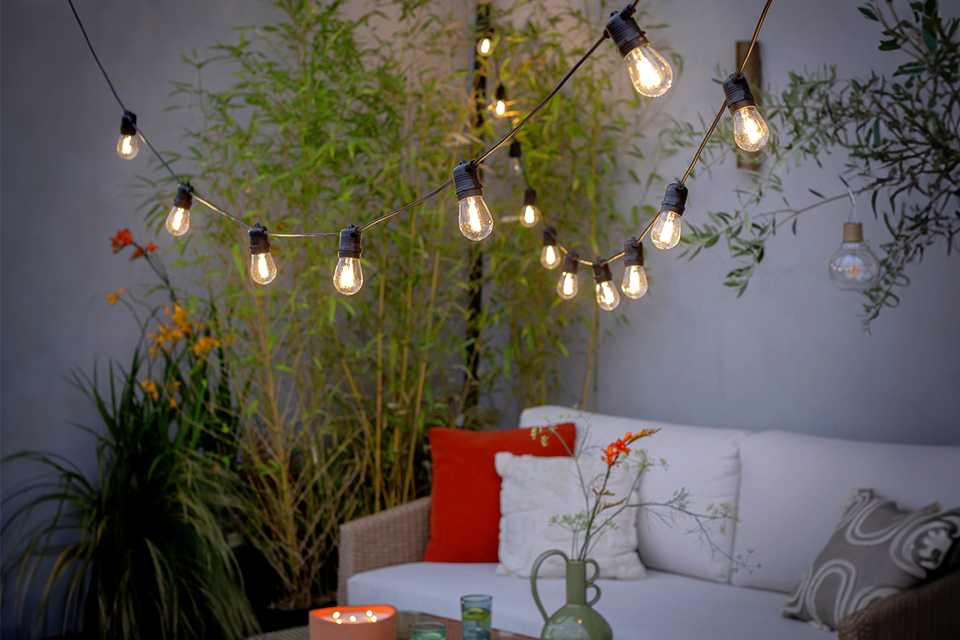 Outdoor string lights hanging above garden.