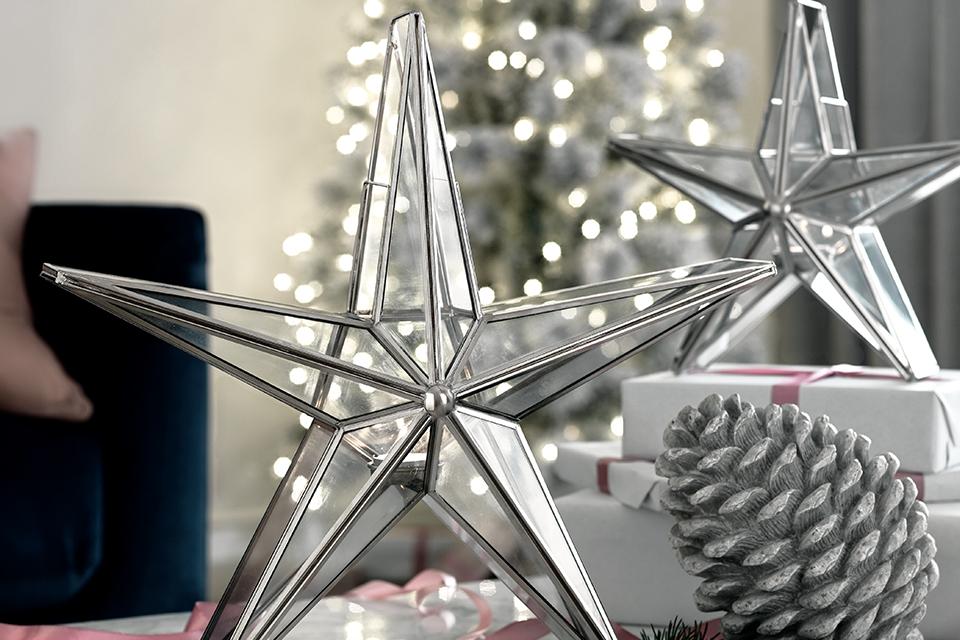 Image of two silver and glass star table decorations.