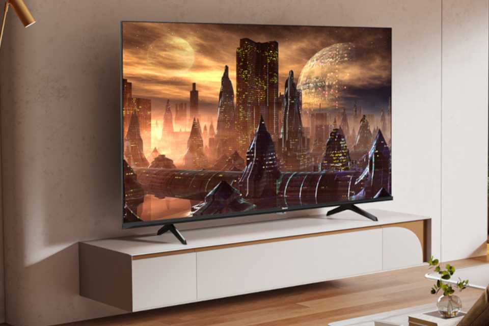 A Hisense E78N Mini-LED 4K TV stood on a TV unit in a living room.