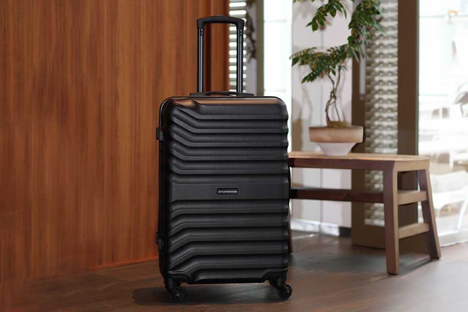 A large black Featherstone 4 wheel hard suitcase.