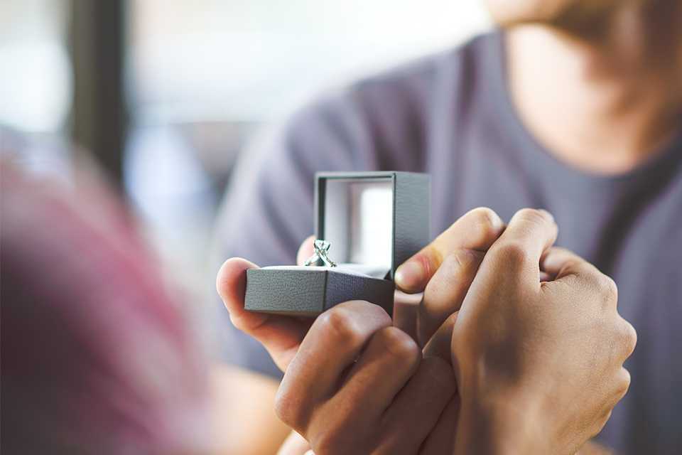 A man proposing with a Revere white gold and diamond engagement ring.