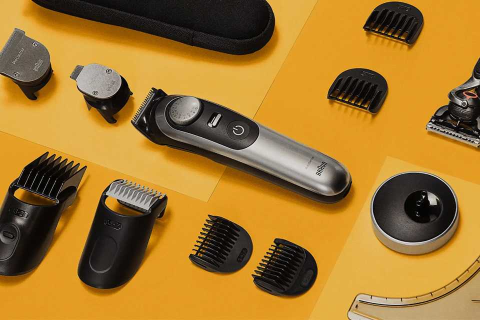 Different parts of a Braun trimmer spread on a yellow floor.