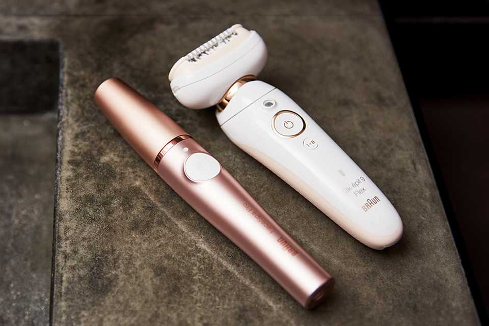 Braun's epilator devices placed next to each other on a marble slab.