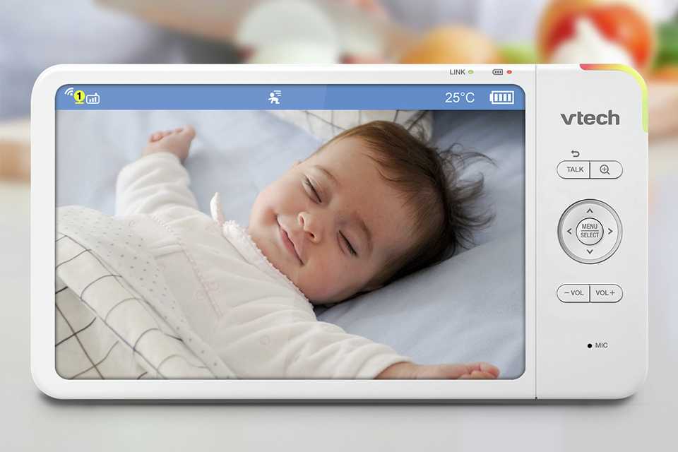 A parent watching a baby sleeping through the VTech VM7367HD 7 Inch Video Baby Monitor.