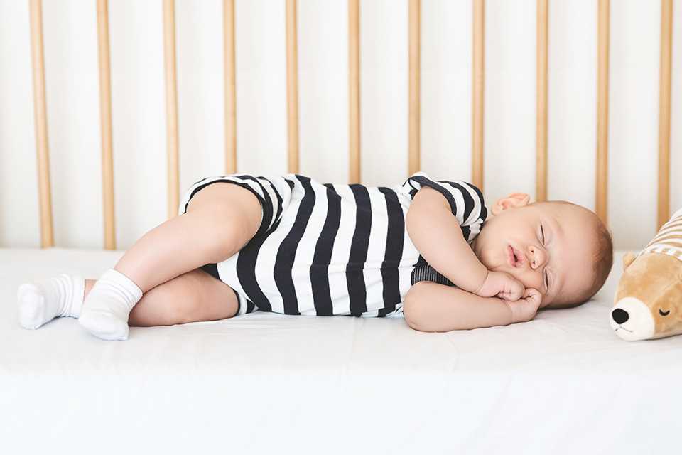 A baby sleeping in a crib.