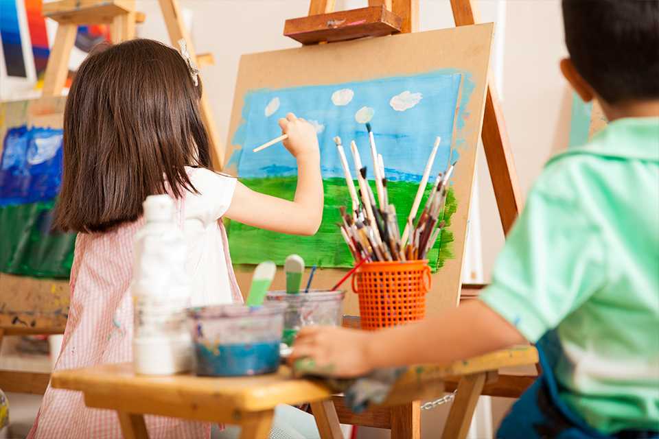 A girl painting a natural scene with glass, sky and clouds.