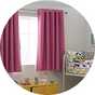 Curtains hanging from a window in the nursery.