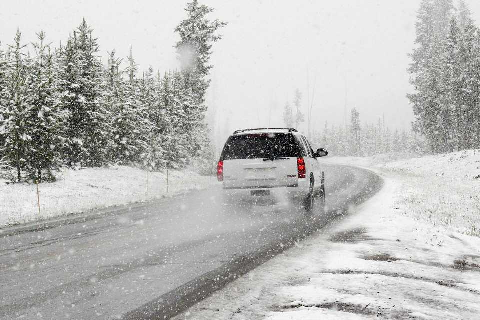 A car driving through a snowfall.