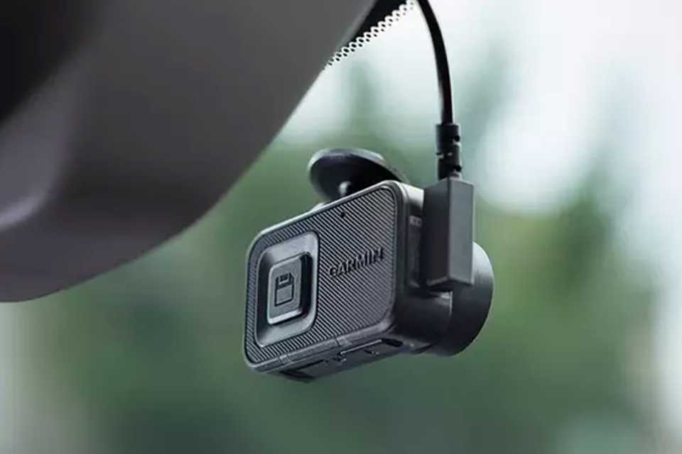 Garmin Mini 3 Dash Cam attached to the rear view mirror of a car.