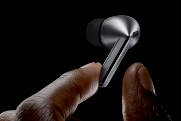 A close-up snapshot of pair of fingers holding Samsung Galaxy Buds3.