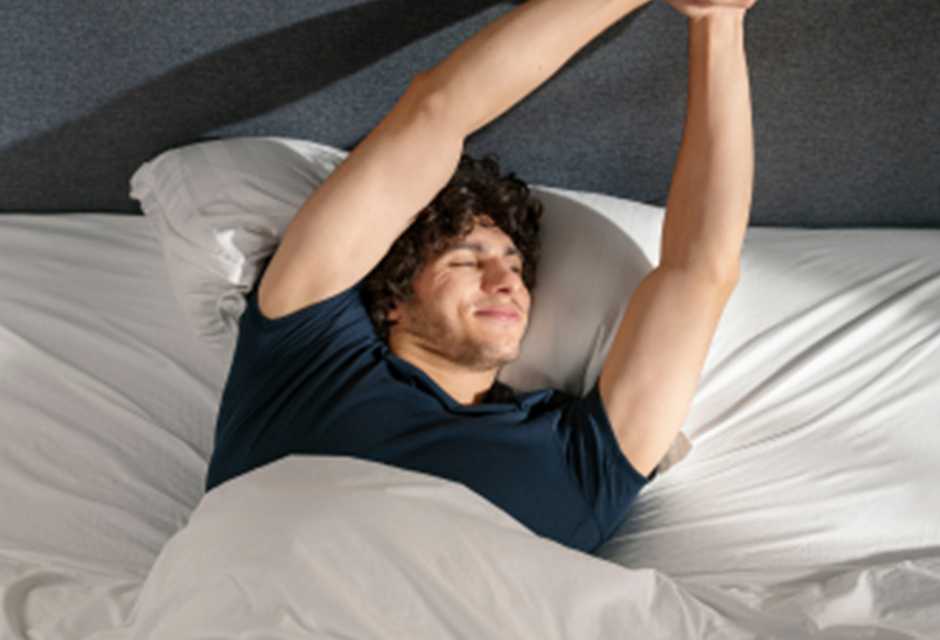 Man waking up in the morning on a Emma mattress.