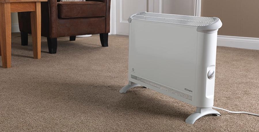 Modern electric heater on floor at home.