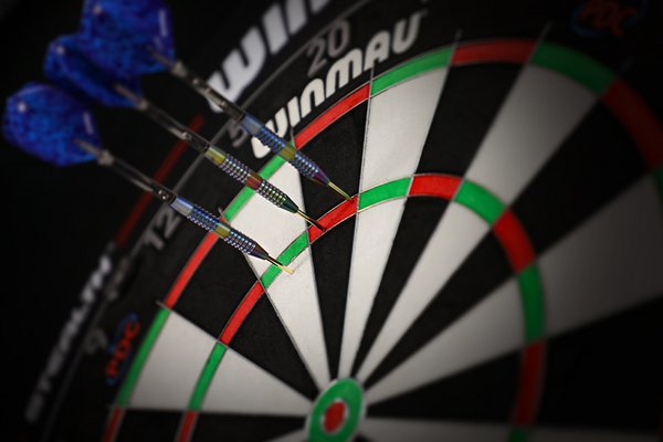 Three blue darts on a Winmau dartboard.