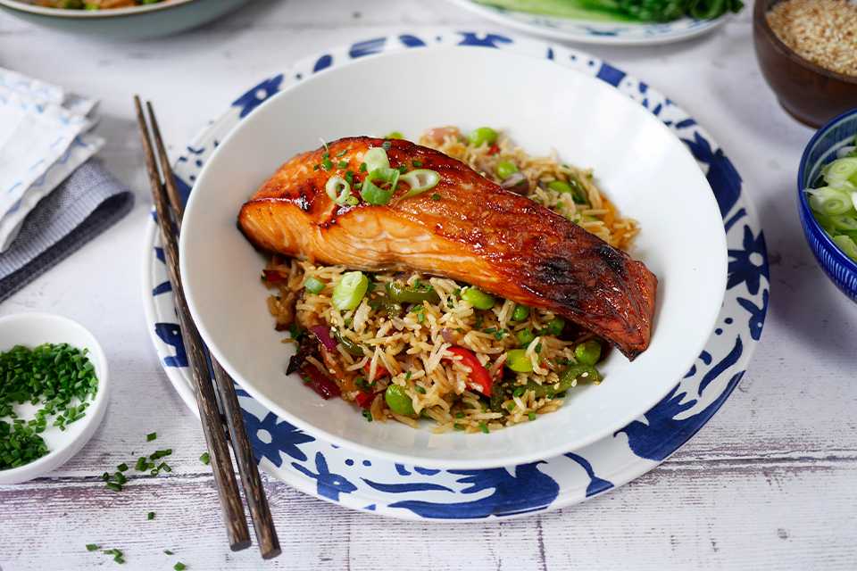 Teriyaki Salmon and Fried Rice with Pak Choi plated in a white bowl.