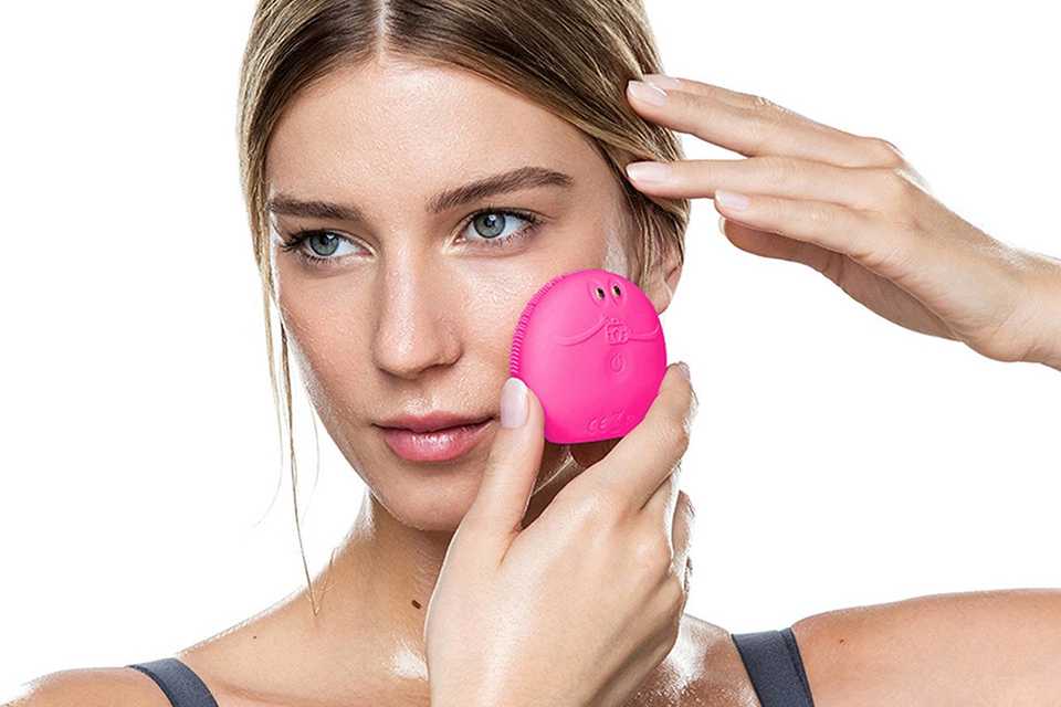woman using facial tool