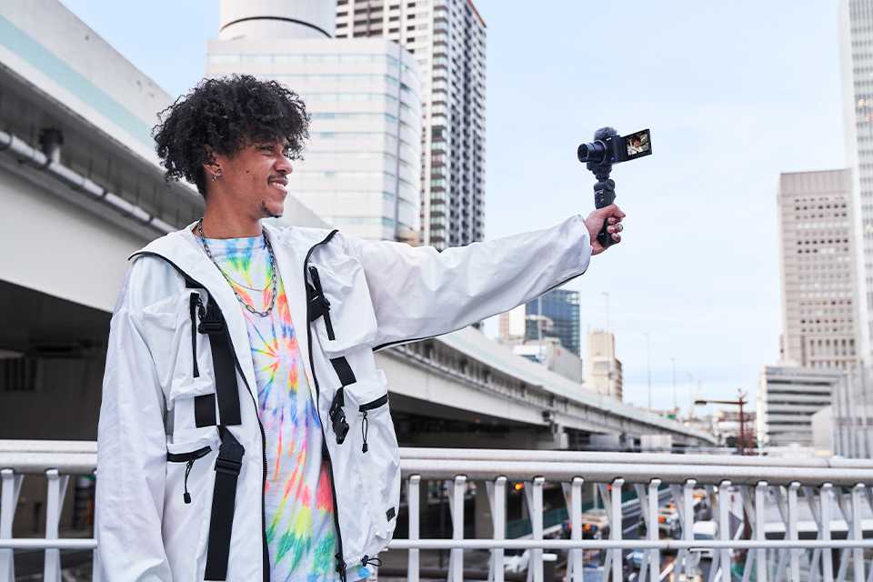 A man vlogging on the streets.