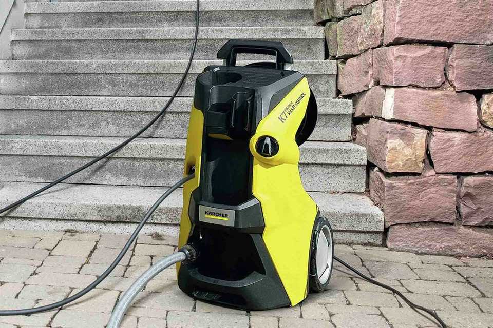 A Kärcher Smart Control Pressure Washer attached to a hose.