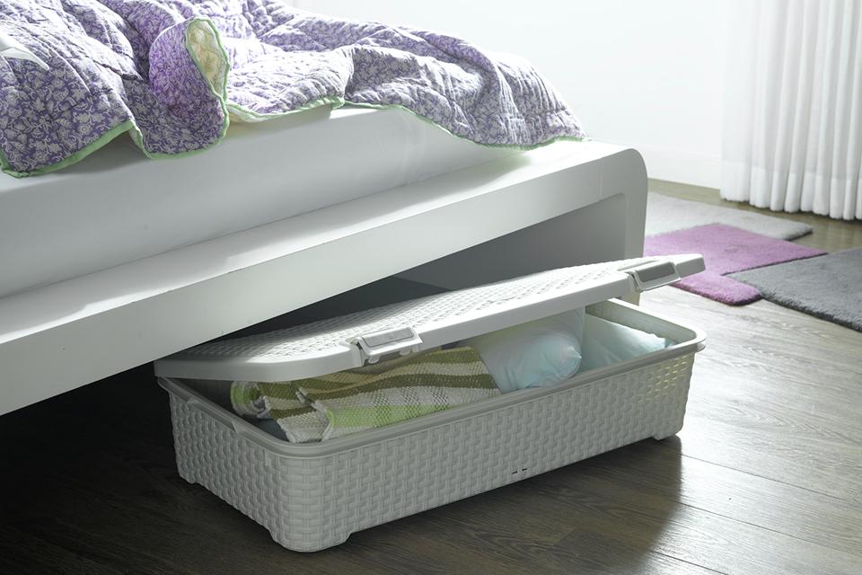 Blankets stored in underbed storage box.