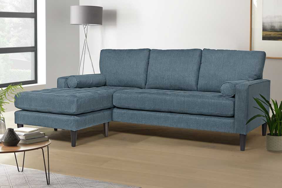 living room with corner sofa, coffee table and lamp.