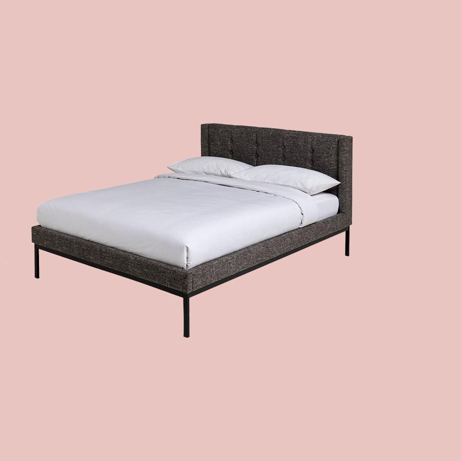 Grey double bed with white bedding.