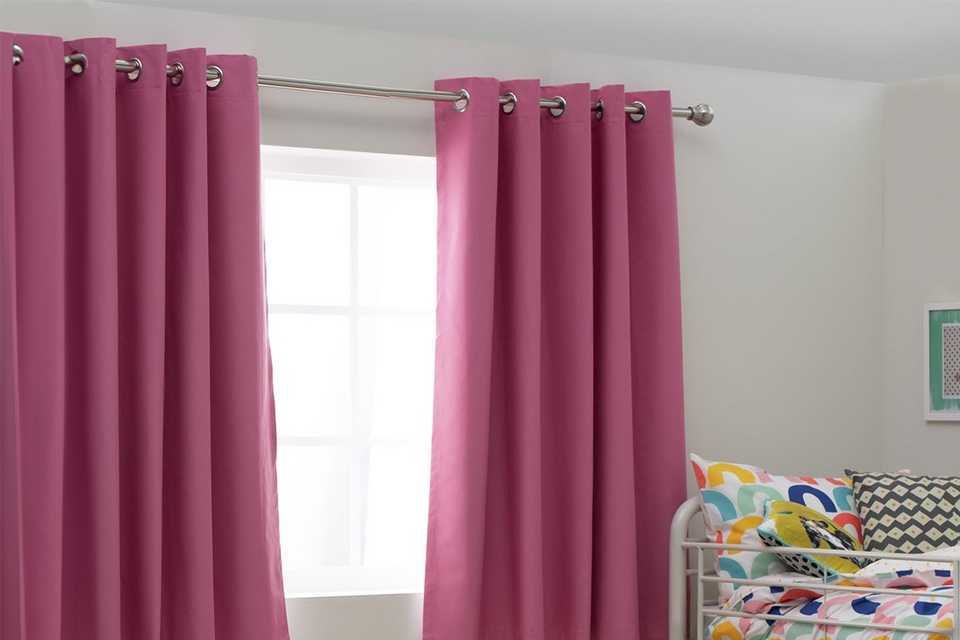 Argos Home Kids Blackout Eyelet Curtains in pink colour put in a kid's bedroom.