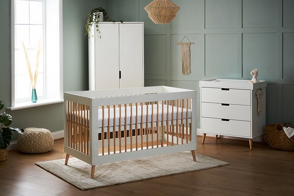 Obaby Maya Cot Bed Nursery Furniture Set - White and Acacia placed in a nursery painted in green colour.