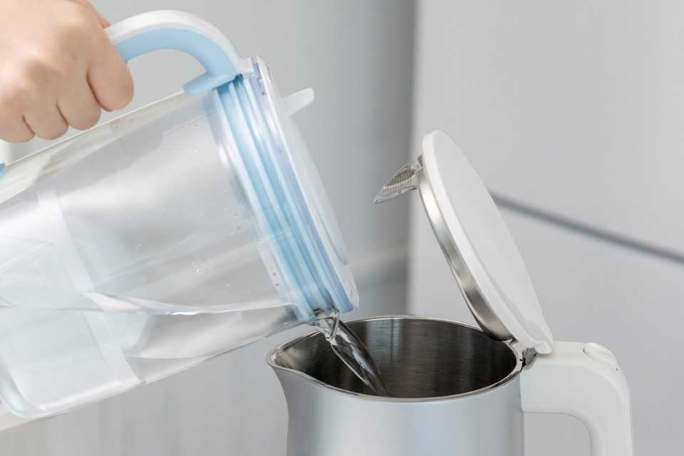 Water decanted from a BRITA jug into a kettle.