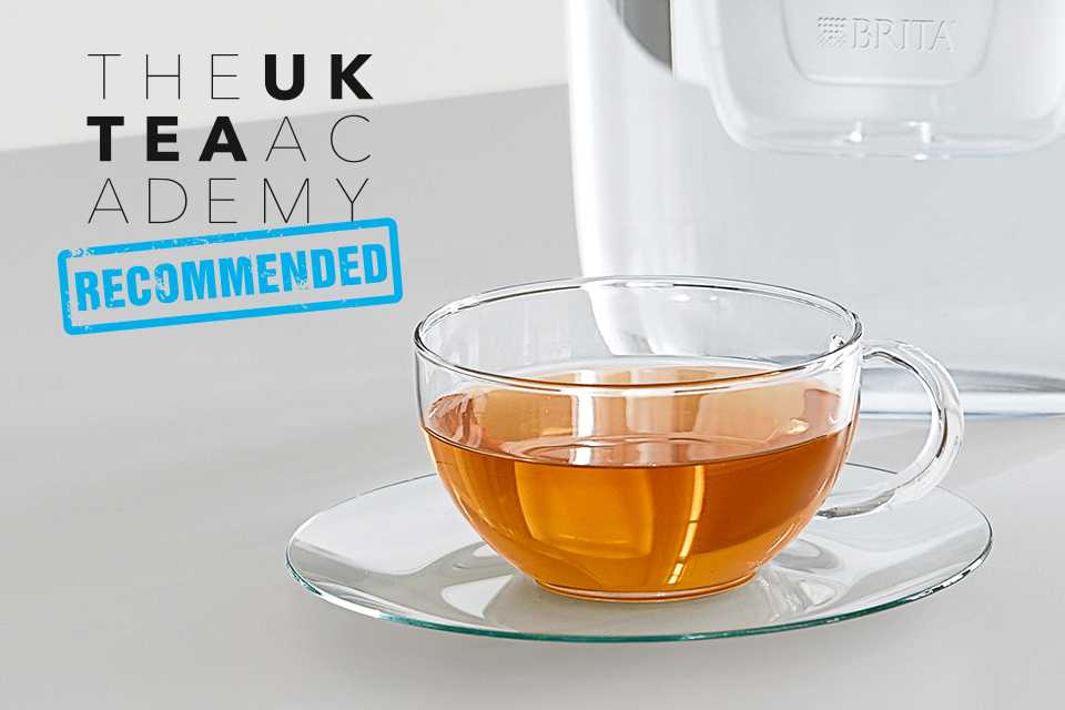 Tea pouring into a glass cup.