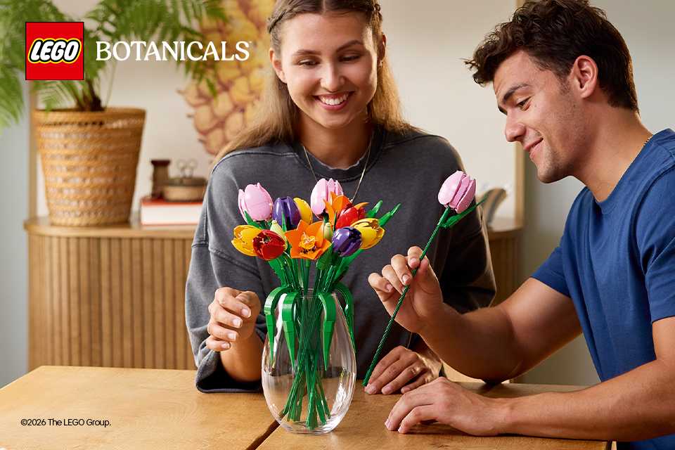 A man and woman admiring the LEGO® Tulips 11501 set.