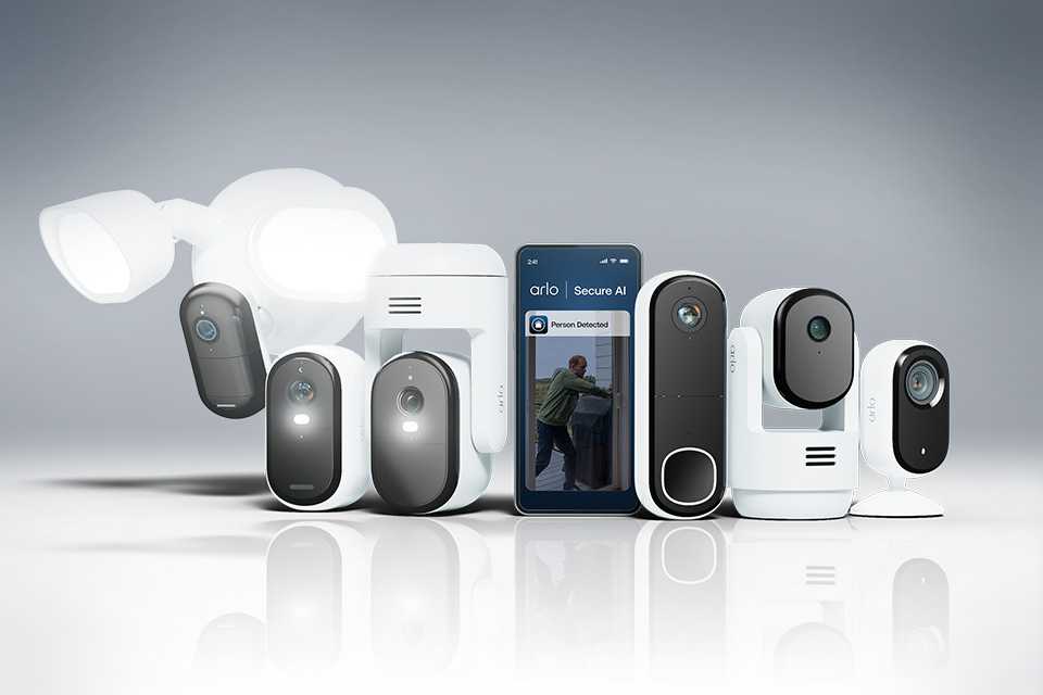 An assortment of white Arlo home security products against a grey background.
