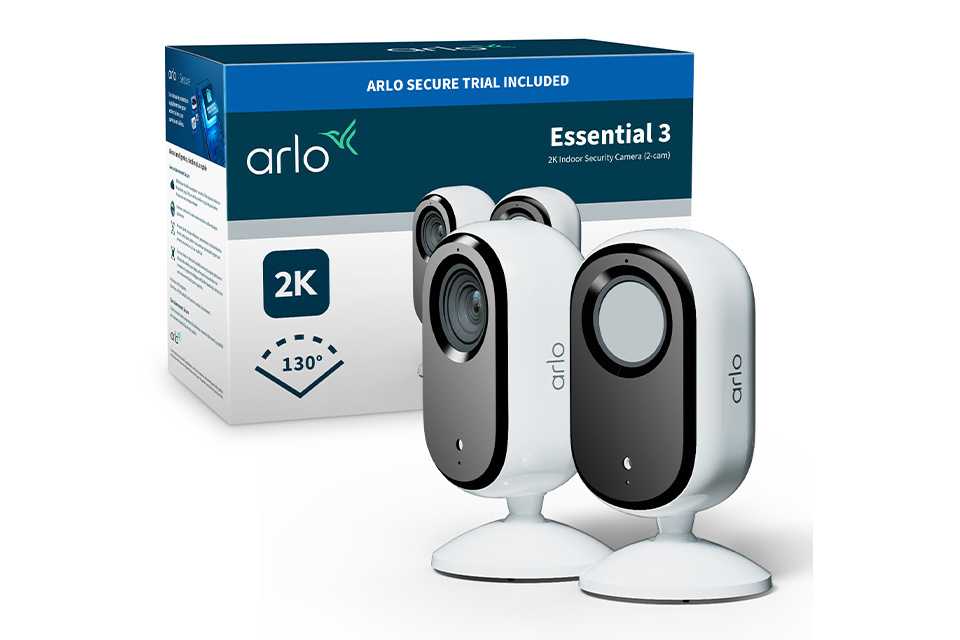 Two white Arlo Essential Indoor 3 2K security cameras shown against their box and a white background.