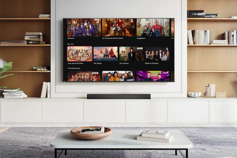 Hisense TV showing a streaming UI placed in a living room setup.