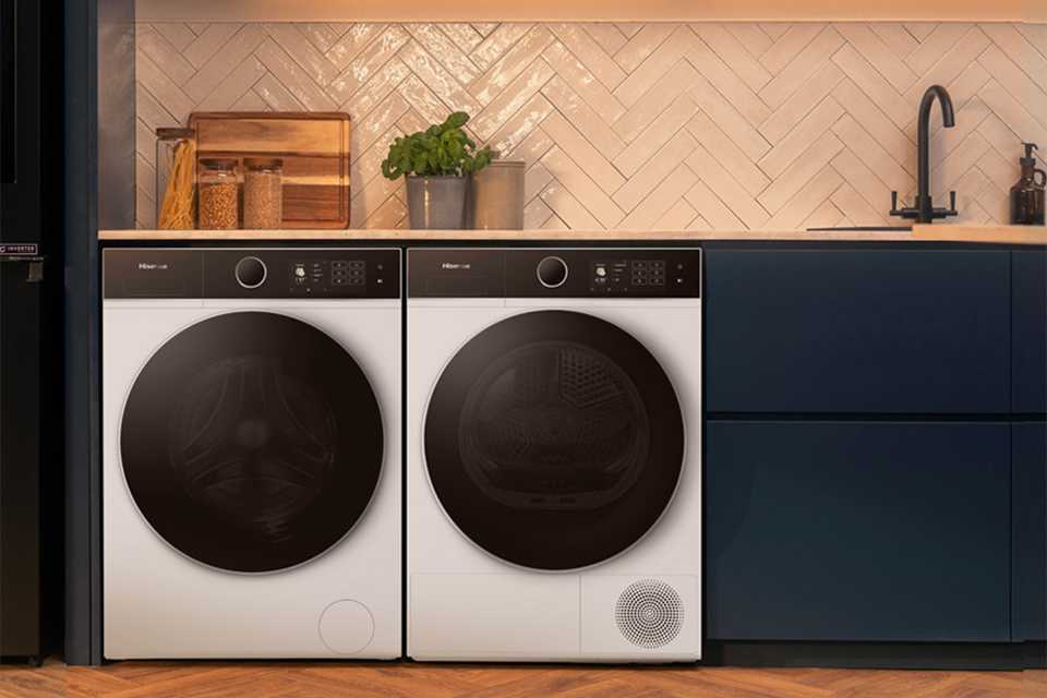 Two Hisense washing machines placed in a laundry room.