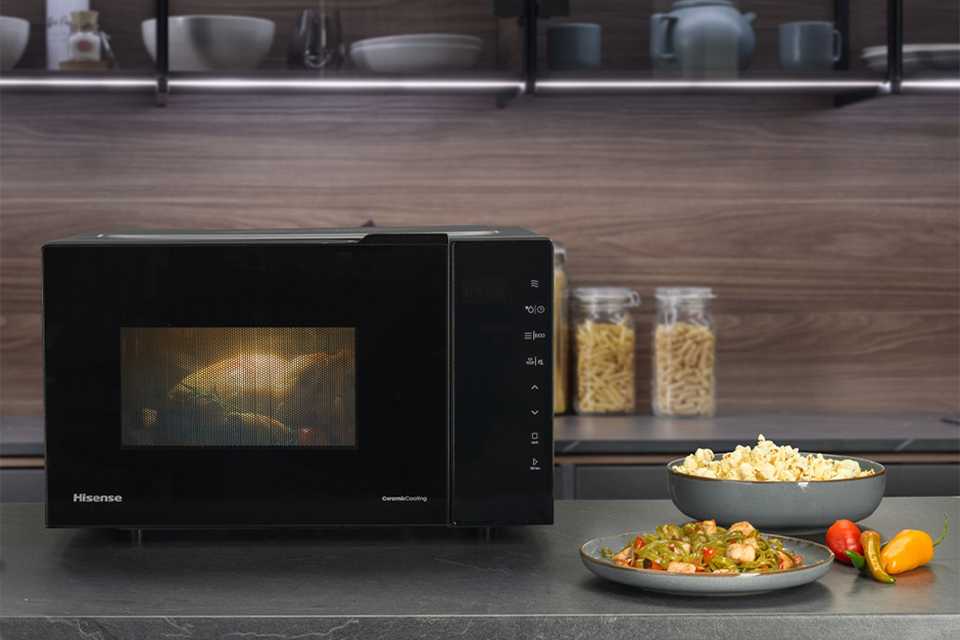 A Hisense microwave placed on a grey countertop.