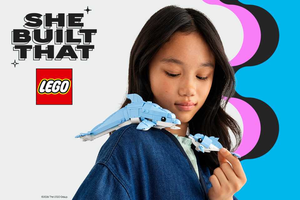 girl playing with a dolphin lego set