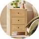 A Habitat wooden bedside table in a bedroom.