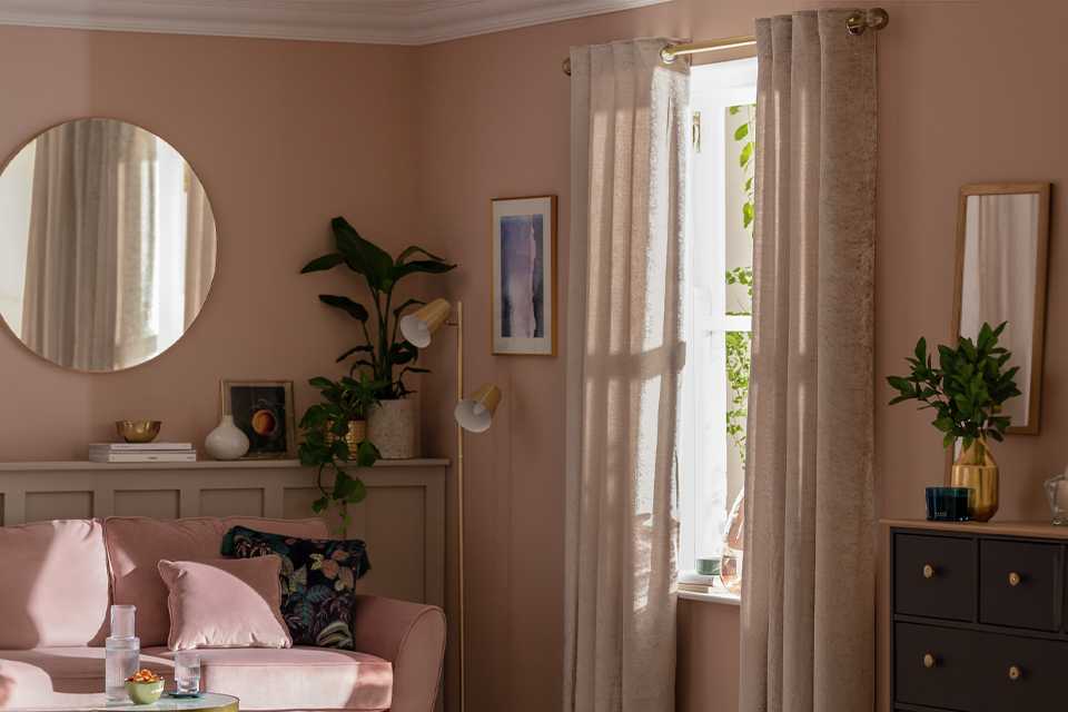 An Argos Home crushed velvet fully lined pair of curtains in champagne colour.